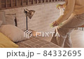 Asian Housewife Dusting Lamp on Nightstand 84332695