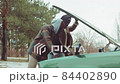 African American Friends Looking under Car Hood and Speaking 84402890