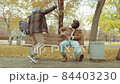 African American Men Meeting in Park and Talking on Bench 84403230