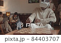 African-American Student Playing Chess in VR Glasses 84403707