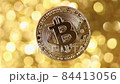 Bitcoin BTC Rotating Bitcoin Gold Coin Rotating on a Golden Background. Close up. 84413056