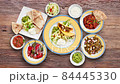 Textured walnut wooden table with Mexican food animated and view from above 84445330