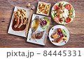 Textured walnut wooden table with Belgian, French food animated and view from above 84445331