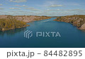 Drone flies over the blue river. Beautiful landscape with a meander river. Flying over a blue lake. Wild nature scene 84482895