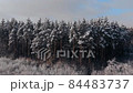 Very beautiful winter landscape in the forest, a lot of snow lies on the trees view height FullHD. Flying over a winter frozen forest with snow-covered trees in winter. 84483737