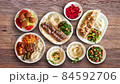Textured walnut wooden table with Syrian food animated and view from above 84592706