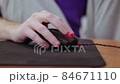 detailed close up on young male gamer hand on computer mouse on black mouse pad 84671110