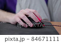 detailed close up on young male gamer hand on computer mouse on black mouse pad 84671111
