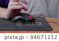 detailed close up on young male gamer hand on computer mouse on black mouse pad 84671112