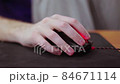 detailed close up on young male gamer hand on computer mouse on black mouse pad 84671114
