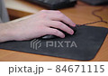 young male gamer hand on computer mouse moving in slow motion on black mouse pad 84671115