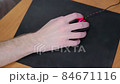 young male gamer hand on computer mouse moving in slow motion on black mouse pad 84671116
