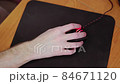 young male gamer hand on computer mouse moving in slow motion on black mouse pad 84671120