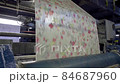 Modern wallpaper production. A machine works, rolling printed newspaper in typography facility. 84687960
