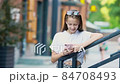 Adorable fashion little girl outdoors in European city 84708493