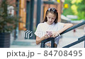 Adorable fashion little girl outdoors in European city 84708495