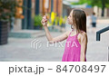 Cute girl gets her face refreshed in hot day 84708497