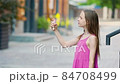 Cute girl gets her face refreshed in hot day 84708499