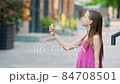 Cute girl gets her face refreshed in hot day 84708501