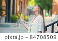 Young beautiful woman gets her face refreshed in hot day 84708509