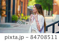 Young beautiful woman gets her face refreshed in hot day 84708511