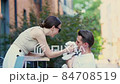 Adorable family of two in city on beautiful spring day 84708519