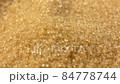 Brown sugar sprinkle on top. Close-up. Cane sugar unrefined, dry demerara. Saccharose 84778744
