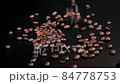 Pouring many roasted coffee beans on the black table on the black background 84778753