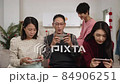 excited asian father pointing at screen and showing off his victory as his happy wife cheering in surprise. family having fun with mobile game at home during spring festival 84906251