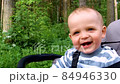 Baby boy smiling and laughing during walk.  84946330