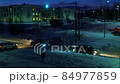 Car traffic at dawn in winter on a poorly lit snowy street in time lapse 84977859
