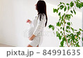 beautiful pregnant woman at home in a white room waiting for a baby 84991635