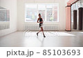 Cute young girl jumping rope in gym, warm up before training 85103693