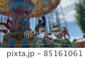 Large Colourful Carousel at the park on blue sky background. Blurred view. 4K 85161061