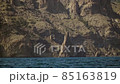 The Republic of Crimea. July 21, 2021. A picturesque view in sunny weather of the Ivan the Robber rock at the foot of the Kara-Dag mountain near the city of Koktebel. The Republic of Crimea. July 21, 2021. A picturesque view in sunny weather of the Ivan the Robber rock at the foot of the Kara-Dag mountain near the city of Koktebel. 85163819