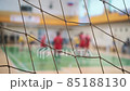 Sports mesh on blurred background of volleyball players. Teamwork and competition concept, selective focus. 85188130
