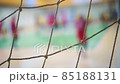 Sports mesh on blurred background of volleyball players. Teamwork and competition concept, selective focus. 85188131