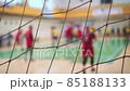 Sports mesh on blurred background of volleyball players. Teamwork and competition concept, selective focus. 85188133