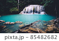 Waterfalls and fish swim in the emerald blue water in Erawan National Park. Erawan Waterfall is a beautiful natural rock waterfall in Kanchanaburi, Thailand.Onsen atmosphere. Fresh nature.4K 85482682