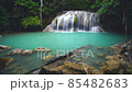 Waterfalls and fish swim in the emerald blue water in Erawan National Park. Erawan Waterfall is a beautiful natural rock waterfall in Kanchanaburi, Thailand.Onsen atmosphere. Fresh nature.4K 85482683