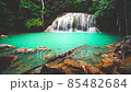 Waterfalls and fish swim in the emerald blue water in Erawan National Park. Erawan Waterfall is a beautiful natural rock waterfall in Kanchanaburi, Thailand.Onsen atmosphere. Fresh nature.4K 85482684