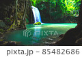 Waterfalls and fish swim in the emerald blue water in Erawan National Park. Erawan Waterfall is a beautiful natural rock waterfall in Kanchanaburi, Thailand.Onsen atmosphere. Fresh nature.4K 85482686