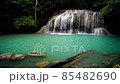 Waterfalls and fish swim in the emerald blue water in Erawan National Park. Erawan Waterfall is a beautiful natural rock waterfall in Kanchanaburi, Thailand.Onsen atmosphere. Fresh nature.4K 85482690