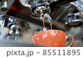 Coffee pouring into ceramic cup 85511895
