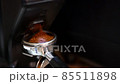 Portafilter with ground coffee near grinder 85511898