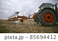 Harvesting in the field. Land cultivation with a tractor 85694412