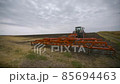 Harvesting in the field. Land cultivation with a tractor 85694463