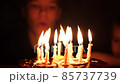 A child blows out the candles on the cake in your birthday. 10 years 85737739