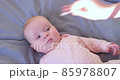 Cleaning and washing baby s face with soft cottong pad. 85978807