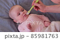 Caucasian mother giving liquid medicine to her baby. Healthcare and child treatment concept. 85981763